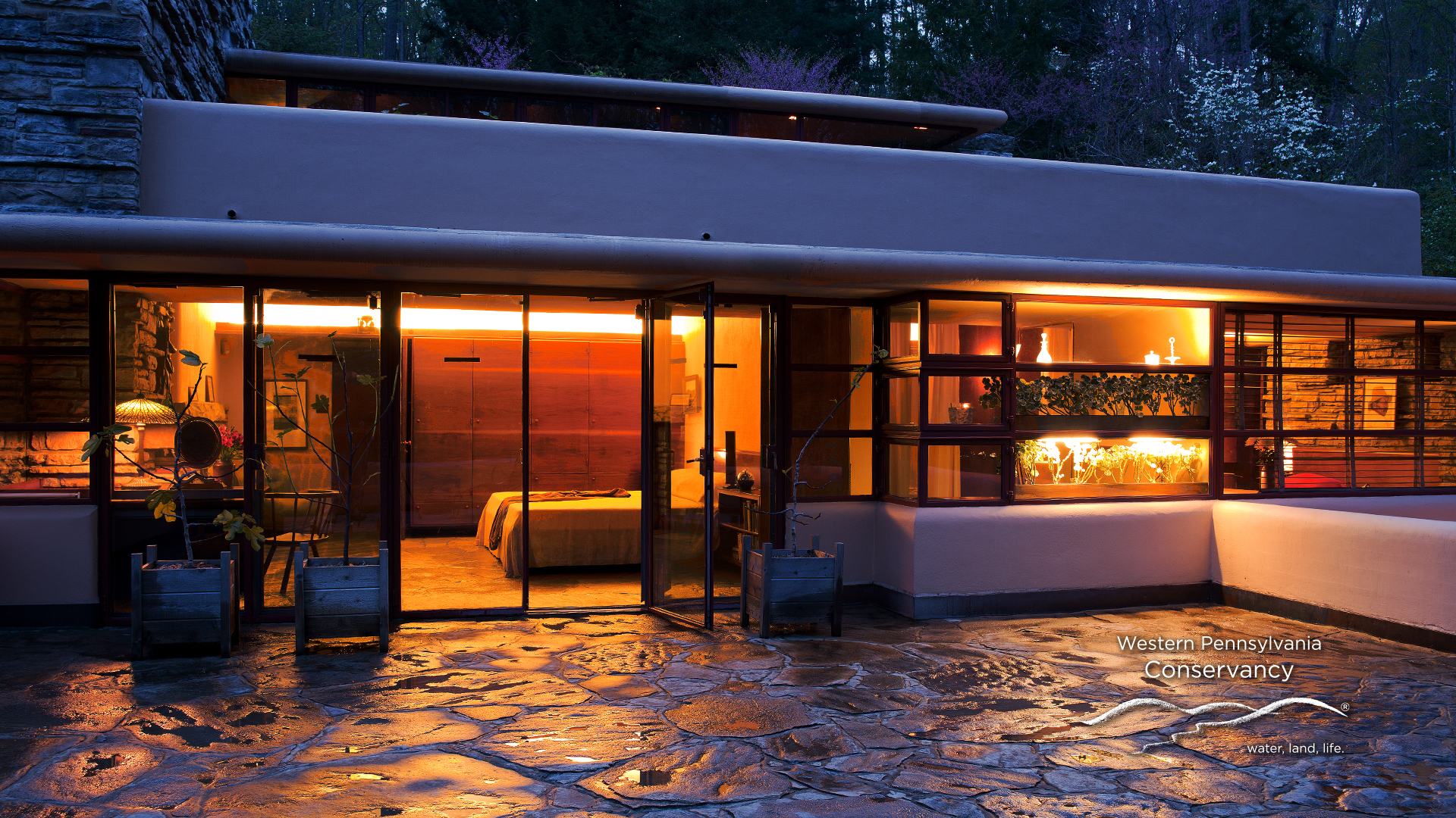 Zoom background image of the south terrace of Fallingwater at night