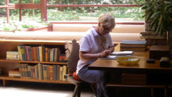 Photo of Fallingwater Institute participant working at the desk in the Fallingwater livingroom