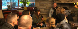 Photo of a group meeting in the living room of the Fallingwater Guest House
