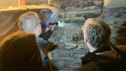 Structural engineers from Atkinson-Noland Associates monitor the void within the Northeast wall of the Guest House.