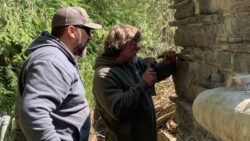 Caleb Moore, senior maintenance specialist, observes as a Graciano team member uses hand tools to remove mortar.