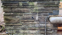 The northeast pier of Fallingwater’s guest house wall showing the original mortar joints, before repointing work by the Graciano team.