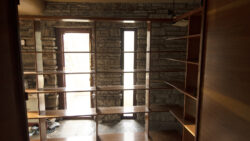 The bookcases and built-in casework were removed from the walls to allow easy access to the stone masonry behind them.