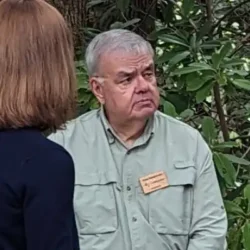 Fallingwater volunteer Tom Seighman interacting with visitors on the grounds at Fallingwater.