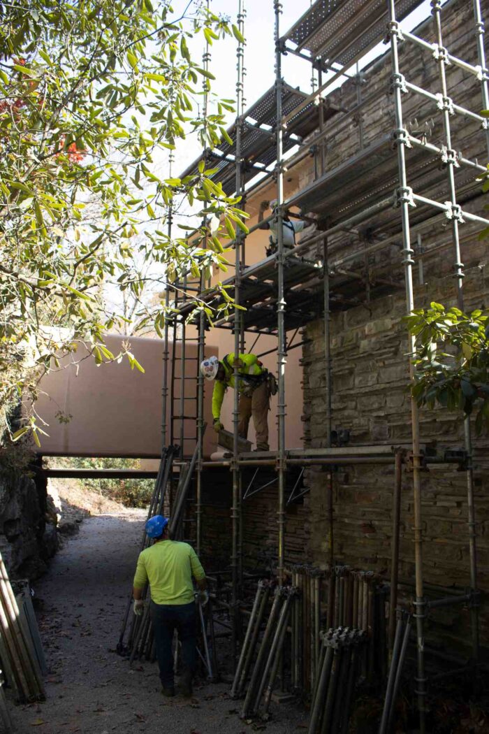 Workers install scaffolding at Fallingwater on Oct. 30.