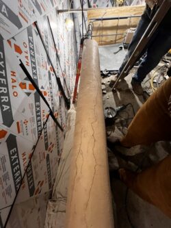 Before demolition, cracks are visible along the top of the terrace wall.