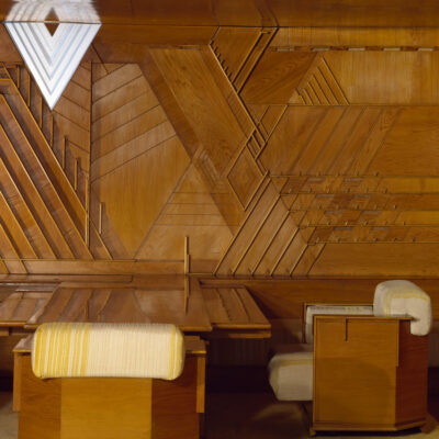 Panelled room used as an office; panels of swamp cypress plywood; office desk & chairs area; designed by Frank Lloyd Wright (1868 - 1959); for the Kaufmann Department Store; Pittsburgh; U.S.A (Pittsburgh); 1937.