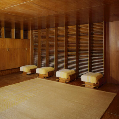 Panelled room used as an office; panels of swamp cypress plywood; office desk & chairs area; designed by Frank Lloyd Wright (1868 - 1959); for the Kaufmann Department Store; Pittsburgh; U.S.A (Pittsburgh); 1937. ©V&A Museum